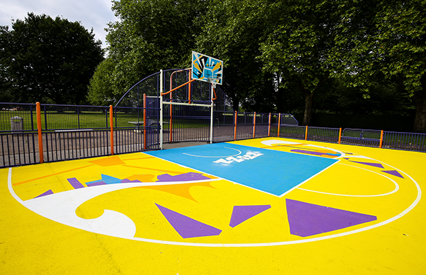 The yellow half of the court design with purple and white geometric shapes
